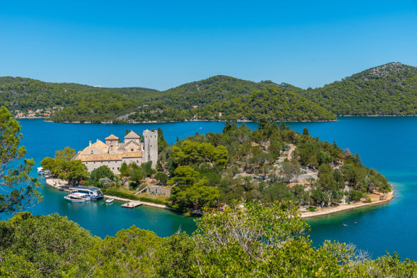 Vista aérea del islote de Santa María en el Gran Lago con el monasterio benedictino visible entre la vegetación, Parque Nacional de Mljet, Croacia.