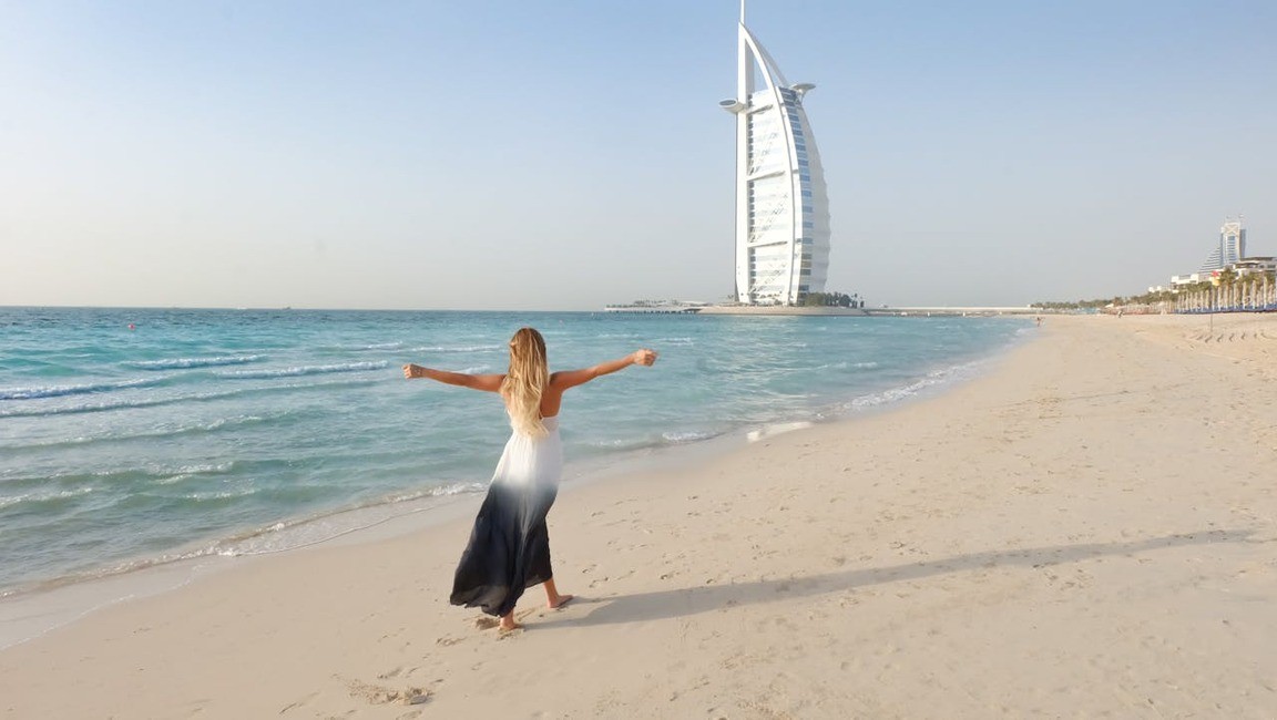 Praia em Dubai com vista para arranha-céus e Burj Khalifa ao fundo, destaque entre as opções de o que fazer em Dubai