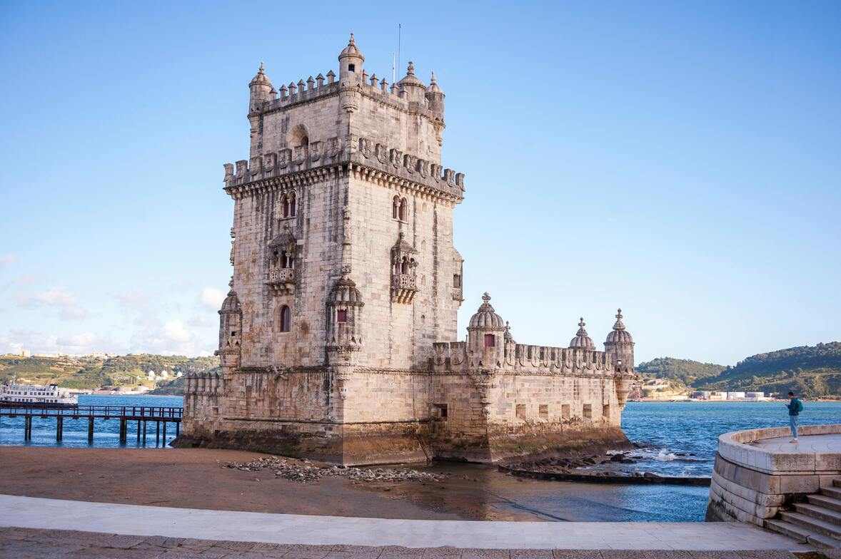 Vista aérea da Praça do Comércio em Lisboa, com turistas caminhando pelo amplo espaço histórico, um dos principais pontos a considerar ao planejar quanto custa uma viagem para Portugal 2025