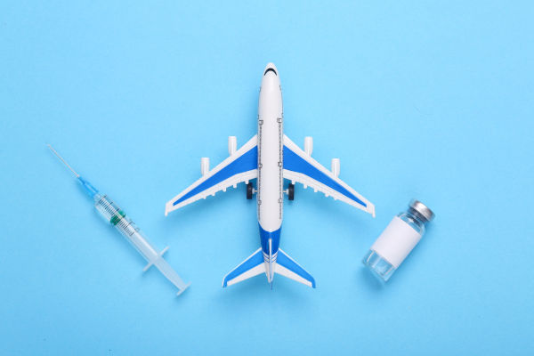 imagen con un avión y una vacuna de la fiebre amarilla.