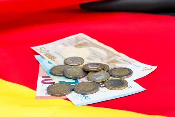 Billetes de euros y monedas sobre una bandera española.